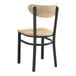 A Lancaster Table & Seating Boomerang chair with a black frame and driftwood seat and back.