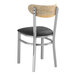 A Lancaster Table & Seating Boomerang series metal chair with a black vinyl cushion and driftwood back.