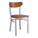 A Lancaster Table & Seating Boomerang Series wooden chair with a metal frame and wooden seat.
