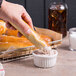 A person holding a Dutch Country Foods soft pretzel stick with salt on it.