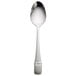 A Oneida Astragal stainless steel serving spoon with a white handle.