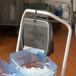 A Rubbermaid Ice Tote Cart with ice in it.