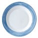 A close-up of a Arcoroc blue and white striped soup plate.
