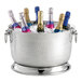 A Tablecraft stainless steel beverage tub on a table with six champagne bottles in it.