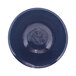A round white melamine bowl with a dark blue rim.