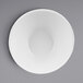 A white Elite Global Solutions Durango melamine bowl on a gray surface.