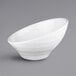 A close-up of a white Elite Global Solutions Durango melamine bowl with a curved edge.