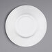 A close-up of an Elite Global Solutions white melamine bowl on a gray surface.