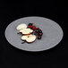 An Elite Global Solutions granite stone melamine plate with apples and cherries on it.