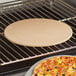 A pizza cooking on an American Metalcraft ceramic pizza stone in an oven.