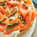 A bagel with smoked salmon and Non-Pareil Capers on a plate.