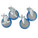 Three silver and blue Advance Tabco casters with wheels.