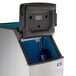 A Manitowoc D420 ice storage bin with a blue lid and blue handle on a blue wall.