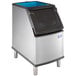 A Manitowoc D320 stainless steel ice bin with a blue lid.