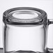 An Arcoroc tempered glass mug with a handle.