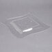 A clear plastic square plate with a white background.