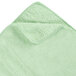 A green microfiber towel with a white edge.
