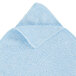 A close-up of a blue microfiber cloth with a white edge.