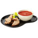 A black GET Let's Party palette plate with food and a bowl of soup and bread.