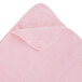 A pink towel with a folded edge.