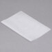 A piece of Durable Packaging interfolded white wax paper on a gray surface.