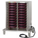 A metal Cambro Camduction charger with purple trays in it.