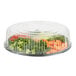 A clear plastic WNA Comet high dome lid on a plastic container with vegetables inside.
