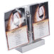 A brushed aluminum Menu Solutions menu tent holding a menu on a table.