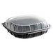 A black plastic 10" x 10" x 3" microwaveable take-out container with a clear lid.
