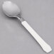 A WNA Comet Reflections Duet plastic teaspoon with a white handle and silver spoon.