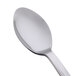 A close-up of a WNA Comet stainless steel look plastic spoon with a silver handle.