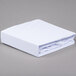 A white JT Eaton twin size bed bug box spring cover folded on a gray surface.