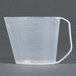 A clear plastic measuring cup with a handle.