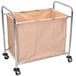A beige Luxor laundry hamper on a metal cart with wheels.