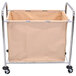 A beige fabric laundry basket on a metal cart with wheels and a handle.