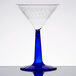 A clear martini glass with a cobalt blue base and stem.