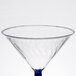 A clear plastic martini glass with a blue rim and base.