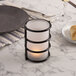 A black Sterno Epic metal candle holder on a table.
