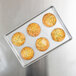A Chicago Metallic pan with six muffins on it.