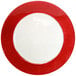 A red glass charger plate with a white rim.