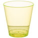 A yellow plastic Fineline shot cup with a green rim.