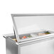 A Beverage-Air stainless steel refrigerated sandwich prep table with glass lids on a counter.