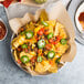 A plate of nachos with Mission yellow triangle corn tortilla chips, cheese, and jalapenos.