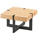 A Cal-Mil square maple riser on a wooden table with black metal legs.