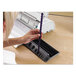A person using a Fellowes Pulsar E electric comb binding machine to bind a purple document.
