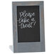 A wooden Cal-Mil Ashwood chalkboard stand with a black chalkboard sign.