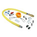 A yellow T&S gas hose with various parts and accessories including silver pipe fittings.