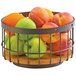 A Cal-Mil Sierra bronze metal basket with a wooden rustic pine accent holding a variety of fruit.