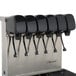 A Servend stainless steel soda fountain machine with six black dispensers.