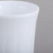 A close up of a white Fineline Flairware plastic coffee mug.